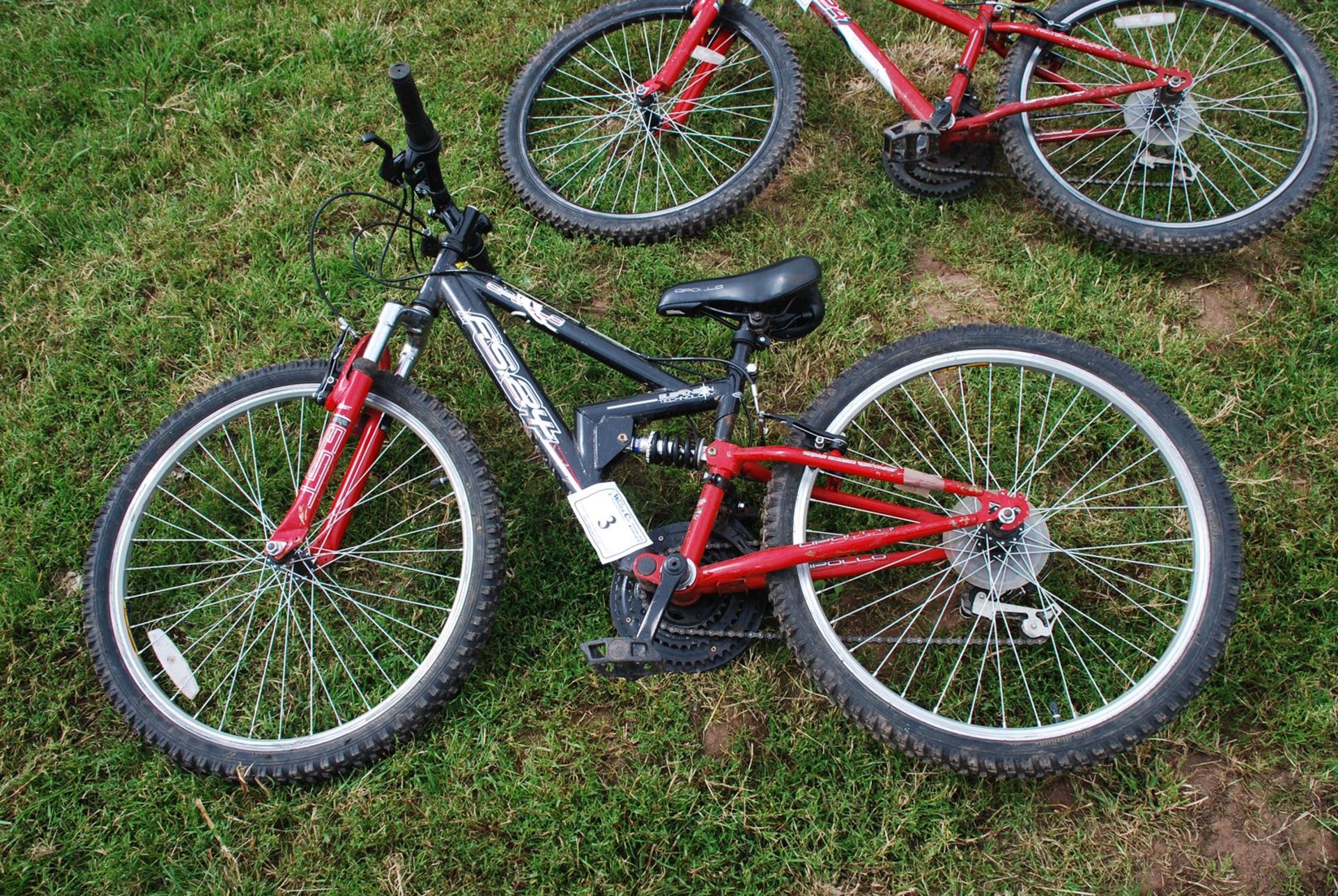 Apollo XC 24 child's bicycle with 18 speed Shimano deraileur gears and front and rear suspension.