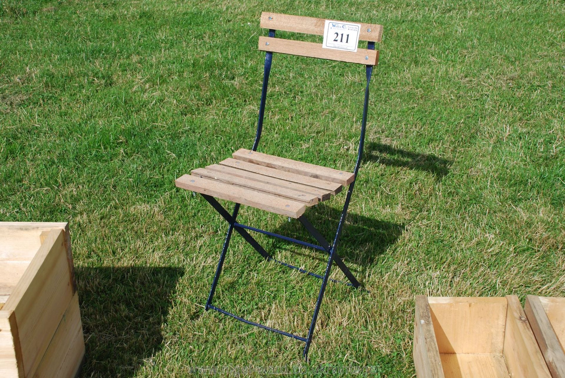 A single metal framed, wooden slatted folding garden chair.