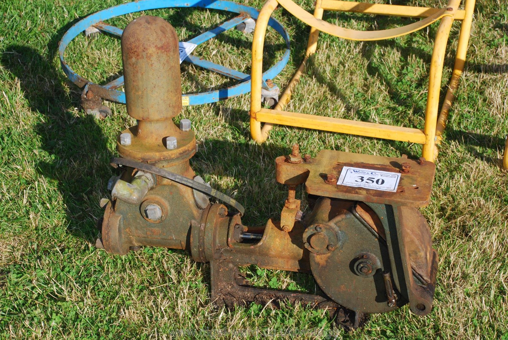 A Lister style reciprocating water pump, rotates freely but has a crack from frost damage.