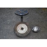 Small circular patio table, steel dog bowls and 155SR 13 Radial tyre on rim.