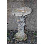 Concrete bird bath on bark texture column