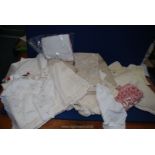 A quantity of beige linen including embroidery, napkins, tablecloths etc.