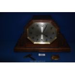 A 1920's Oak mantle Clock, with key and pendulum, Arabic numerals, 13'' wide.