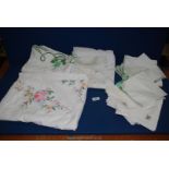 A pack of five embroidered Tablecloths and 24 napkins.