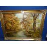 A gilt framed Oil on canvas of a river landscape, signed lower right A.