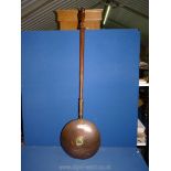 A Victorian copper warming pan.