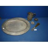 A pewter platter, ashtray, hot water jug and brass shoe horn, etc.