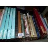 A box of books: Antiques Roadshow Quiz Book, A Vision of Eden, Lilies of The Field etc.