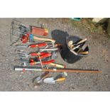 Quantity of Wolf tools, garden hand tools, axe and various other garden hand tools.