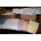 Two boxes of various bed linen including flanelette sheets.