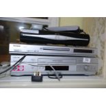 A Skybox, DVD player and VHS player with remotes.