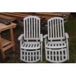 Two folding reclining garden chairs.