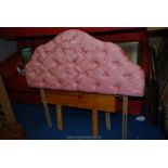 A pink single headboard.