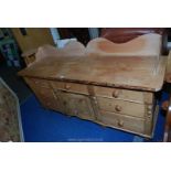 A pine sideboard having three drawers and cupboard to centre 6' x 40" x 21 1/2".