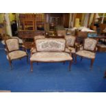 A needlepoint two seater sofa and three matching chairs and a lower armchair.