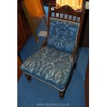 Mixed wood framed Edwardian fireside chair in Osborne & Little blue shadow pattern fabric