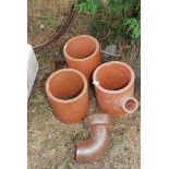 Three terracotta chimney stoves, 10" diameter and a salt glazed drainage bend.