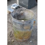 Galvanized dustbin with holes, converted to brazier.