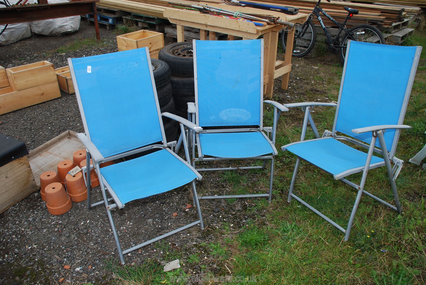 Three nylon and metal folding chairs.