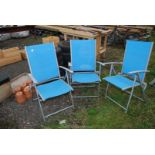 Three nylon and metal folding chairs.