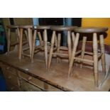 A set of four kitchen stools, plus a similar one.