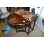 Domed end gate leg table with barley twist legs.