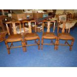 Four dining chairs with drop-in seats.