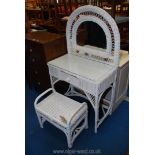 A glass topped wicker dressing table with matching stool 31" x 55" x 17".