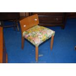 A floral upholstered dressing table stool/chair.