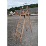 A five rung wooden set of stepladders.