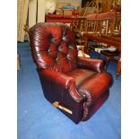 A red leather effect reclining armchair.