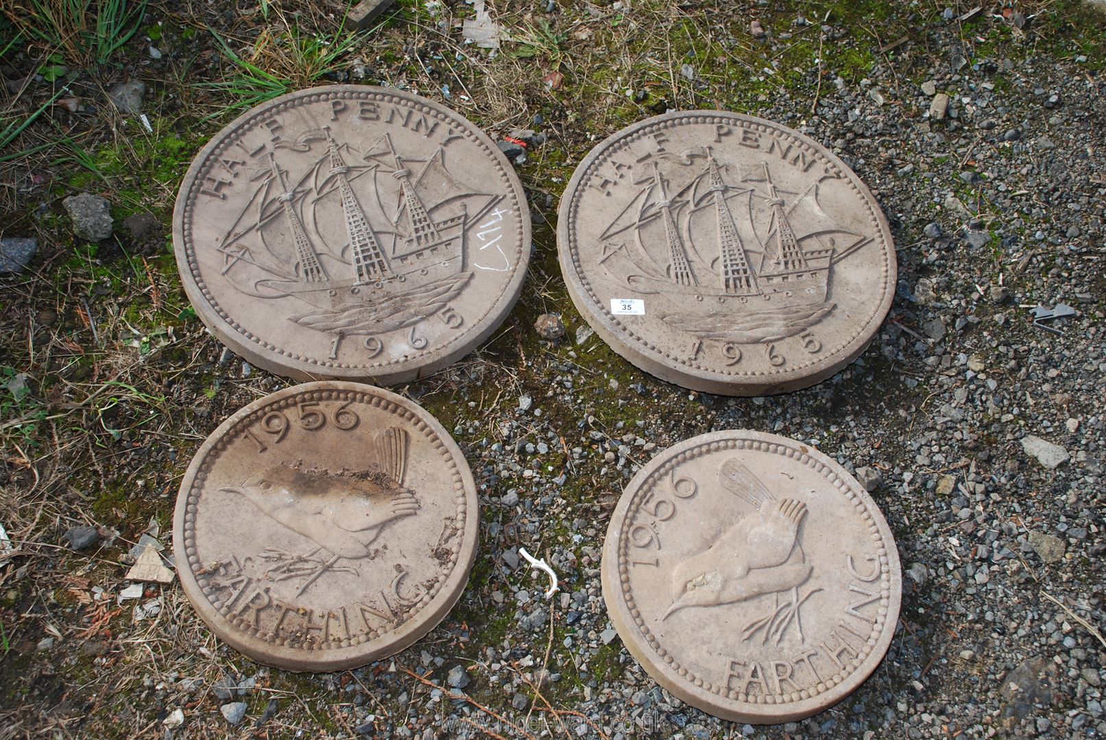 Four circular coin garden stepping stones in the form of half penny,