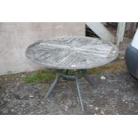 A wooden patio table, 47" diameter.