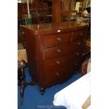 A bow fronted two over three chest of drawers.