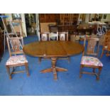 A 44" oak circular dining table extending to 5' 30" high and four dining chairs with floral