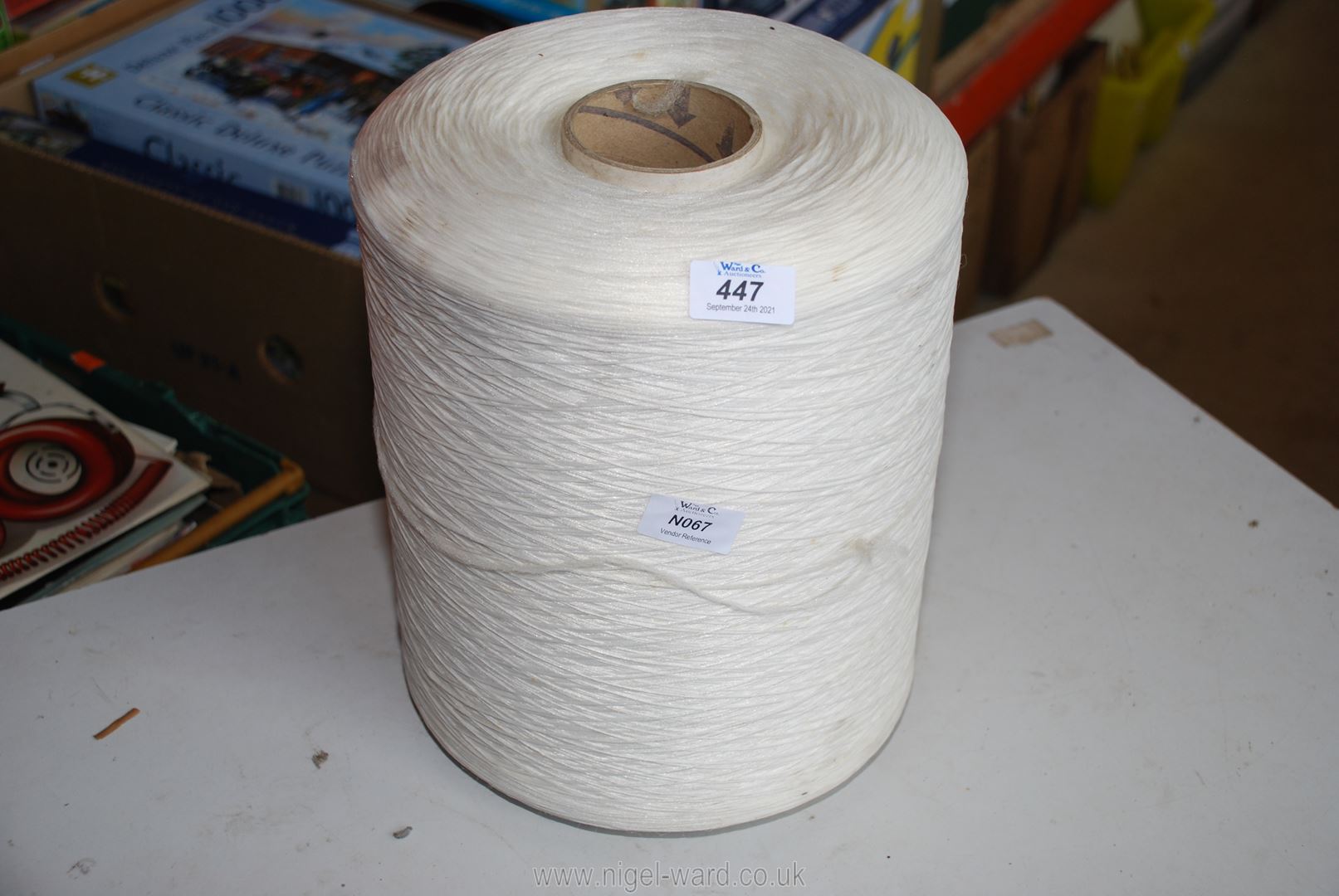 Large coil of white synthetic thread.