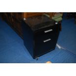 A black finish suspended file/two drawer cabinet on wheels.