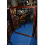 A bevelled wall mirror 53" x 41".