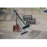 Two wall hanging planters, brooms, rake etc.