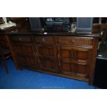 A three drawer over three cupboard sideboard 60" x 34" x 16".