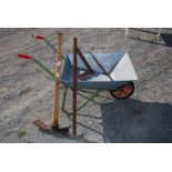 Metal wheelbarrow on solid tyre, pick, bar and square.