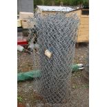 Coil of used galvanized fencing.