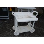 A folding plastic garden drinks trolley on wheels.