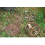 Four cast iron wheels, various sizes.