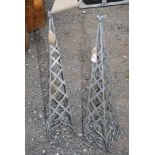 Two metal garden obelisks.