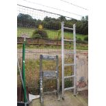 A folding surveyors ladder and a single six run aluminium ladder.