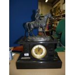 A highly polished black stone cased Mantle Clock having recessed panels depicting dueling soldiers