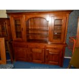 A contemporary peg-joyned Oak dresser having an arched central shelf area flanked by opposing