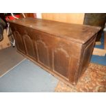 A circa 1800 peg joined four panel Blanket chest/Arms chest having shaped raised and fielded panels,