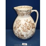A vintage jug, cream with brown flowers, 10 1/2" tall.